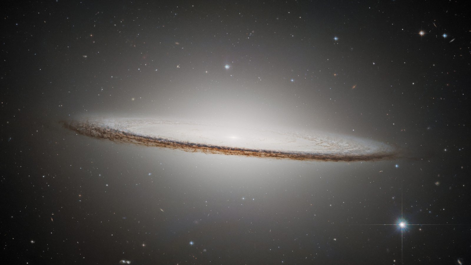 The Sombrero Galaxy’s bright central bulge and dark dust lane against a field of stars.